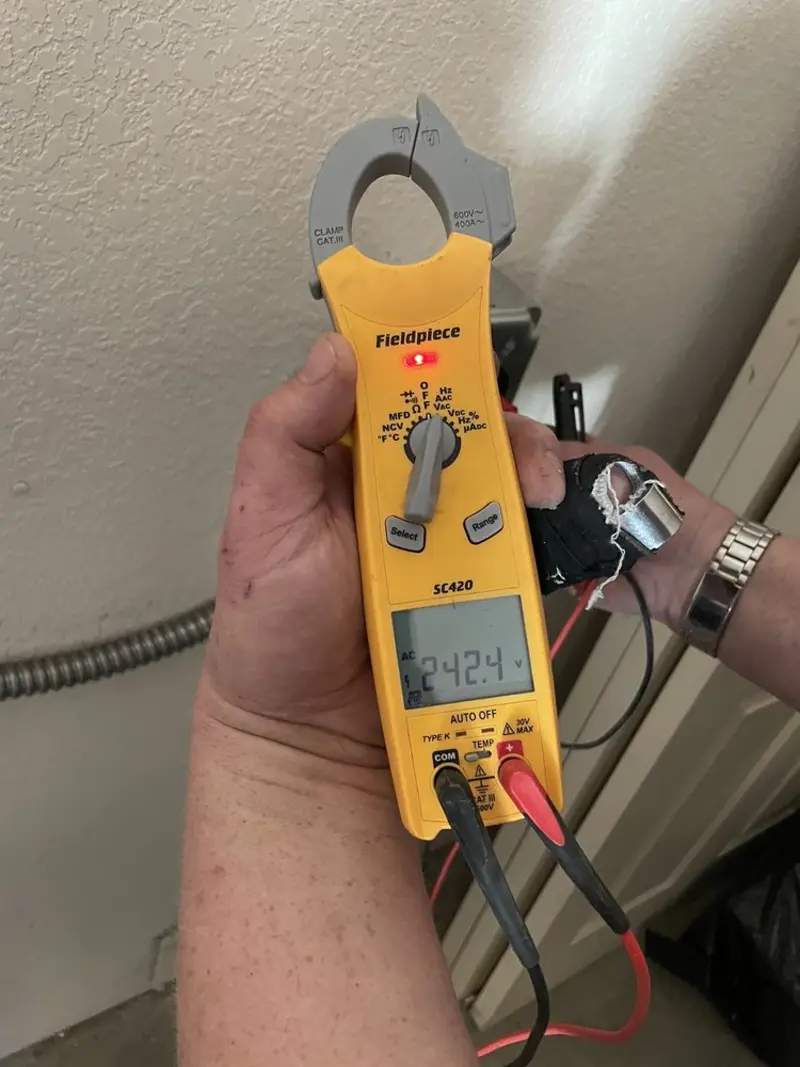 Voltage testing with clamp meter during Ceiling Fan Installation in Mathis
